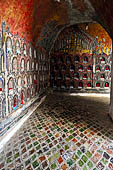 Myanmar, Burma, Nyaungshwe. Small Buddhas set into the temple wall, Shwe Yaunghwe Kyaung monastery, near Inle Lake. 